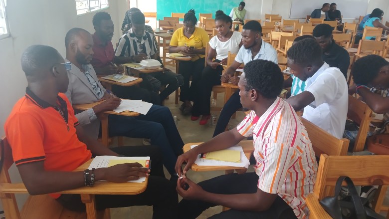 Northeastern Public University students discussing in a group during the Patriotic Congress for the National Rescue on June 11, 2025. Photo by Edxon Francisque/ The Haitian Times.