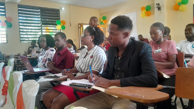 Members of the dean's office of the three UPSEJ faculties, Management Education and Agronomy, write down the proposals and recommendations for the speakers and participants during the patriotic congress on national preservation, on Friday, June 13, 2025, at the UPSEJ Faculty of Education. Photo by Danise Davide Lejustal for The Haitian Times.
