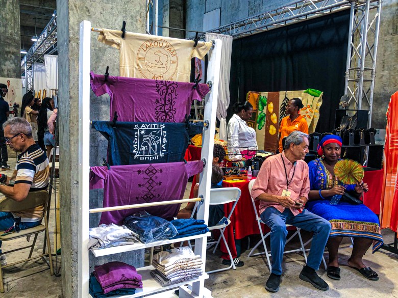 The Lakou Pam booth featured T-shirts adorned with vèvè symbols and illustrations of Haiti’s natural beauty and mountainous landscapes, offered to the public at the first edition of the HAIFEX Women’s Entrepreneurship Fair, held in Pétion-Ville on July 6 and 7, 2025. Photo by Juhakenson Blaise/The