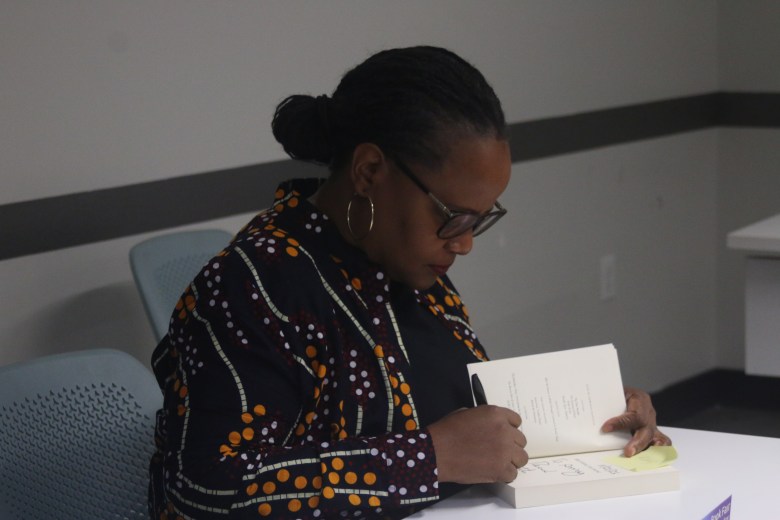 Haitian-American writer Edwidge Danticat signs a book after taking part in a panel discussion at Miami Dade College during the Miami Book Fair on Sunday, Nov. 23, 2025. Photo by Béatrice Vallières for The Haitian Times.