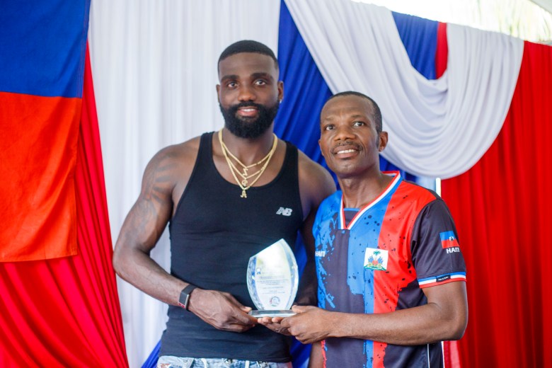 Frantzdy Pierrot poses alongside former lawmaker Frandy Louis after receiving an honor plaque at Bas-Limbé’s City Hall on Friday, July 10, 2026. Photo by Ketlain Difficile for The Haitian Times.
