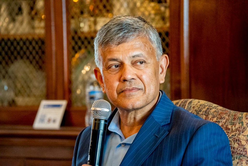 Vijay Dandapani, president and CEO of the Hotel Association of New York City, speaks during a fireside chat on immigration policy and New York’s hospitality workforce at Brooklyn College in Brooklyn on July 30, 2026. Fredner Cayemitte / The Haitian Times